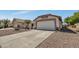 A single-story desert home featuring a terracotta roof and gravel landscaping at 23075 W Arrow Dr, Buckeye, AZ 85326