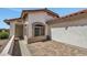 Close-up of home exterior with brick paved patio and stucco facade at 23075 W Arrow Dr, Buckeye, AZ 85326