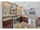 Modern kitchen features stainless steel appliances, dark wood cabinets, and a stylish tile backsplash at 23075 W Arrow Dr, Buckeye, AZ 85326