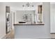 Open-concept kitchen with breakfast bar, stainless steel refrigerator, and stylish light fixtures at 23075 W Arrow Dr, Buckeye, AZ 85326