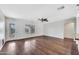 A well-lit living room featuring hardwood floors, ceiling fan, and neutral walls at 23075 W Arrow Dr, Buckeye, AZ 85326