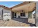 A covered patio with brick pavers, ceiling fan, exterior door, and desert decor at 23075 W Arrow Dr, Buckeye, AZ 85326