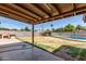 View of the backyard featuring a patio, mature landscaping and block wall at 233 E 7Th Dr, Mesa, AZ 85210