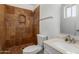 Bathroom featuring a walk-in shower adorned with decorative tiles, a toilet, and a sleek sink at 233 E 7Th Dr, Mesa, AZ 85210