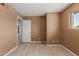 View of bedroom with open door, tiled floors, and ample natural light coming through the window at 233 E 7Th Dr, Mesa, AZ 85210