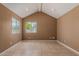 An empty bedroom boasts tiled floors, a high vaulted ceiling, and abundant natural light from the window at 233 E 7Th Dr, Mesa, AZ 85210