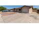 View of the exterior with a concrete driveway and a partial desert landscape at 233 E 7Th Dr, Mesa, AZ 85210