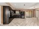 Kitchen featuring dark cabinetry, tile floors and a sliding glass door to the backyard at 233 E 7Th Dr, Mesa, AZ 85210