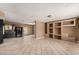 Spacious living room featuring tile flooring and custom built-in shelving at 233 E 7Th Dr, Mesa, AZ 85210