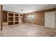 Bright living room featuring tile flooring and custom built-in shelving at 233 E 7Th Dr, Mesa, AZ 85210