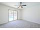 Well-lit bedroom with a sliding glass door, neutral carpet, and a view of the pool at 2337 E Contessa St, Mesa, AZ 85213