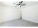 Bright bedroom featuring neutral carpet, ceiling fan, and a door to the rest of the home at 2337 E Contessa St, Mesa, AZ 85213