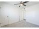 Neutral bedroom with plush carpeting, ceiling fan, and white doors provides a tranquil space at 2337 E Contessa St, Mesa, AZ 85213