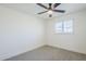 Bright bedroom features a modern ceiling fan and a window with plantation shutters at 2337 E Contessa St, Mesa, AZ 85213