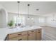 Bright, open kitchen featuring modern cabinetry, quartz countertops, and a charming bay window seating area at 2337 E Contessa St, Mesa, AZ 85213