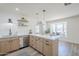 Kitchen with island seating, modern cabinets, stainless steel appliances, and a view to living area at 2337 E Contessa St, Mesa, AZ 85213