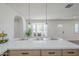 Modern kitchen with quartz countertops, custom cabinets, pendant lighting, and a bay window seating area at 2337 E Contessa St, Mesa, AZ 85213
