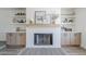 Fireplace featuring custom shelving, modern decor, and hardwood floors at 2337 E Contessa St, Mesa, AZ 85213