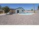 Wide shot of the backyard featuring a private pool with gravel landscaping at 2337 E Contessa St, Mesa, AZ 85213
