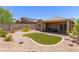 Beautiful backyard with a small grass area and covered patio perfect for entertaining and enjoying the outdoors at 2458 W Warren Dr, Anthem, AZ 85086