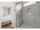 Modern shower featuring gray tile surround, pebble floor, and built-in shower niche at 2458 W Warren Dr, Anthem, AZ 85086