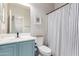 Well-lit bathroom with modern sink, framed art, and striped shower curtain at 2458 W Warren Dr, Anthem, AZ 85086