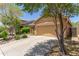 Charming single-story home featuring a well-manicured front yard, desert landscaping and a two-car garage at 2458 W Warren Dr, Anthem, AZ 85086