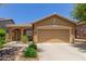 Charming single-story home featuring a well-manicured front yard and a two-car garage at 2458 W Warren Dr, Anthem, AZ 85086