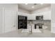 Well-lit kitchen with white cabinets, modern appliances, and a convenient breakfast bar at 2458 W Warren Dr, Anthem, AZ 85086