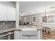 Bright kitchen featuring white cabinets, stainless steel appliances, and stylish backsplash at 2458 W Warren Dr, Anthem, AZ 85086