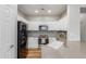 Modern kitchen with stainless steel appliances, white cabinets, and stylish backsplash tiles at 2458 W Warren Dr, Anthem, AZ 85086