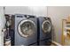 Well-equipped laundry room with modern washer and dryer units and ample storage at 2458 W Warren Dr, Anthem, AZ 85086