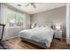 Cozy bedroom featuring a comfortable bed, wood floors, and natural light from the window at 2458 W Warren Dr, Anthem, AZ 85086