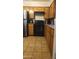 Functional kitchen featuring wooden cabinets, practical appliances, and easy-to-clean tile flooring at 265 W 17Th Ave, Apache Junction, AZ 85120