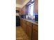 Functional kitchen featuring wooden cabinets, practical appliances, and easy-to-clean tile flooring at 265 W 17Th Ave, Apache Junction, AZ 85120