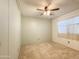 Bedroom with a ceiling fan, a window with valance and a closet at 2701 E Allred Ave # 171, Mesa, AZ 85204