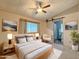 Comfortable bedroom with a ceiling fan, sliding door to bathroom, and modern decor at 2701 E Allred Ave # 171, Mesa, AZ 85204