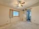 Bedroom with a ceiling fan, a window, and sliding door to the ensuite bathroom at 2701 E Allred Ave # 171, Mesa, AZ 85204