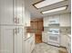Well-lit kitchen with white appliances, spacious cabinets, and easy access to an adjoining room at 2701 E Allred Ave # 171, Mesa, AZ 85204