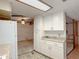 Efficient kitchen with white cabinets, modern appliances, and a clear view to an open living area at 2701 E Allred Ave # 171, Mesa, AZ 85204