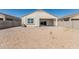 View of the backyard featuring a covered patio and low-maintenance desert landscaping at 3112 N 303Rd Dr, Buckeye, AZ 85396