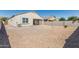 Backyard featuring low-maintenance landscaping, block fence, and covered patio at 3112 N 303Rd Dr, Buckeye, AZ 85396