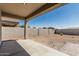 Picture of the home's backyard, which features a covered patio and rock landscaping at 3112 N 303Rd Dr, Buckeye, AZ 85396