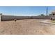 Spacious backyard with gravel landscaping and privacy fencing offers low maintenance at 3112 N 303Rd Dr, Buckeye, AZ 85396