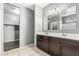 Bathroom featuring dual sinks and vanity with dark wood cabinetry and a walk-in closet at 3112 N 303Rd Dr, Buckeye, AZ 85396