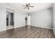 Spacious bedroom with hardwood floors, ceiling fan, and lots of natural light at 3112 N 303Rd Dr, Buckeye, AZ 85396