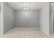 Empty dining room featuring tile floors and a modern chandelier at 3112 N 303Rd Dr, Buckeye, AZ 85396