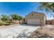 Single-story home featuring a two-car garage and desert landscaping at 3112 N 303Rd Dr, Buckeye, AZ 85396