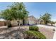 Single-story home featuring a two-car garage and desert landscaping at 3112 N 303Rd Dr, Buckeye, AZ 85396