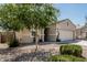 Single-story home featuring a two-car garage and desert landscaping at 3112 N 303Rd Dr, Buckeye, AZ 85396